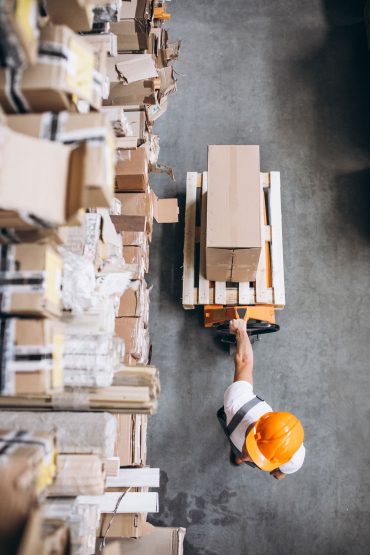 young-man-working-warehouse-with-boxes